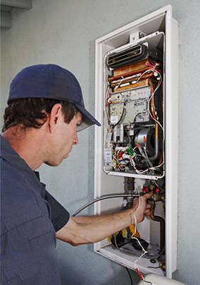 Gilbert plumbing professional maintains a tankless water heater